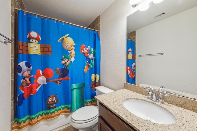 full bathroom featuring shower / bath combination with curtain, vanity, and toilet