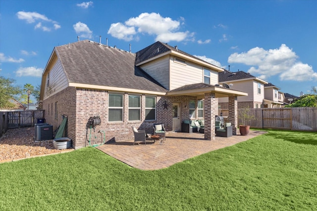 rear view of house with a lawn, an outdoor living space, central air condition unit, and a patio