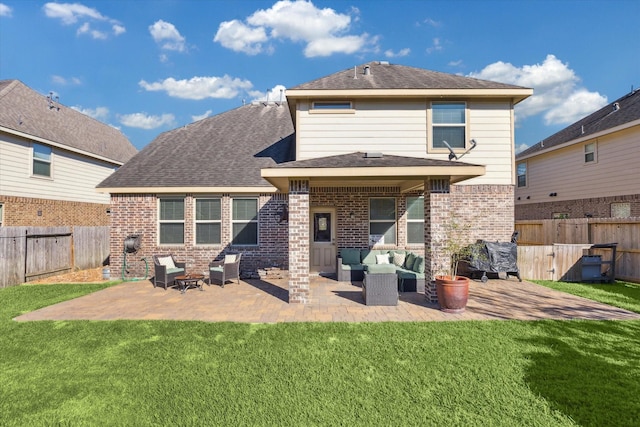 rear view of property with a lawn, a patio area, and an outdoor hangout area