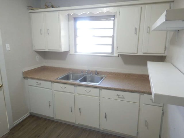 kitchen featuring dark hardwood / wood-style flooring, sink, and white cabinets