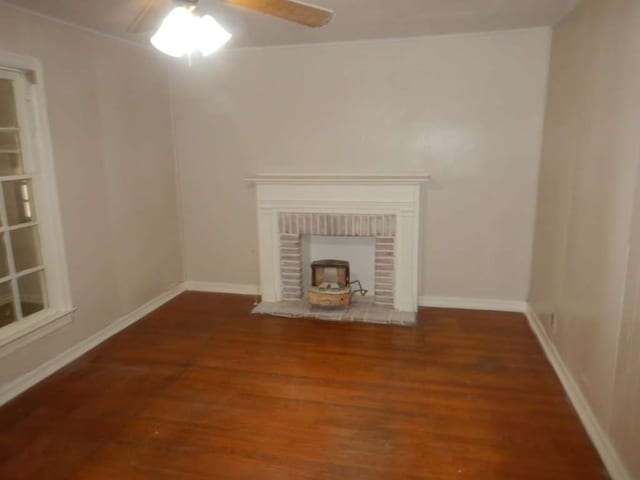 unfurnished living room with dark hardwood / wood-style floors and ceiling fan