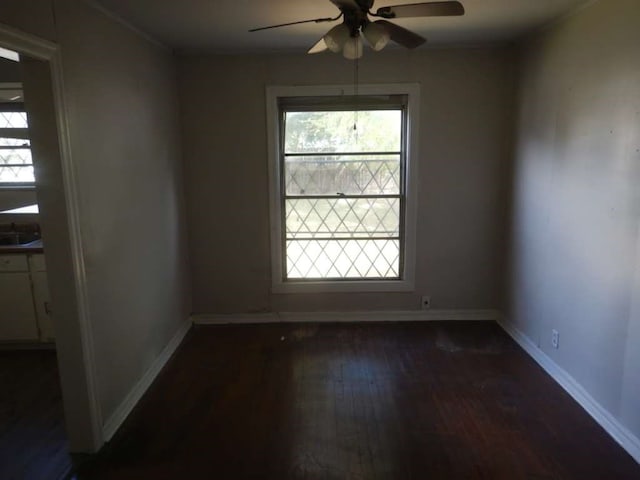 unfurnished room featuring dark wood-type flooring and ceiling fan