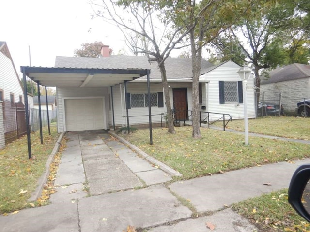 ranch-style home with a front lawn, a garage, and a carport