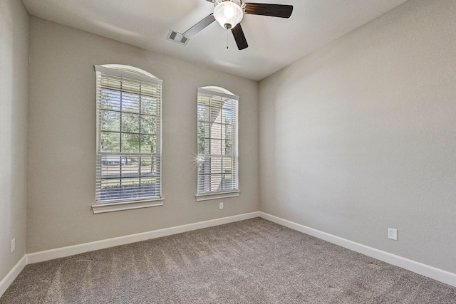 carpeted spare room with ceiling fan