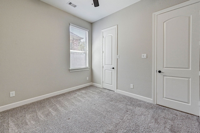 unfurnished bedroom with light carpet and ceiling fan