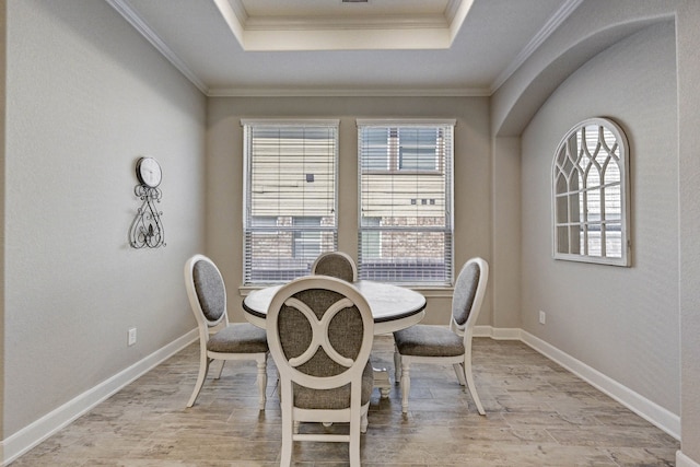 dining room featuring a tray ceiling and crown molding