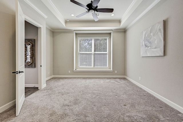 unfurnished bedroom with carpet flooring, a raised ceiling, ceiling fan, and ornamental molding