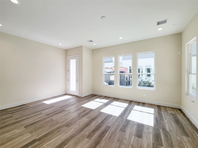 unfurnished room with wood-type flooring