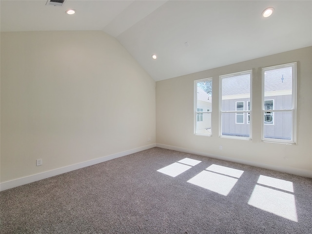 spare room with vaulted ceiling and carpet floors