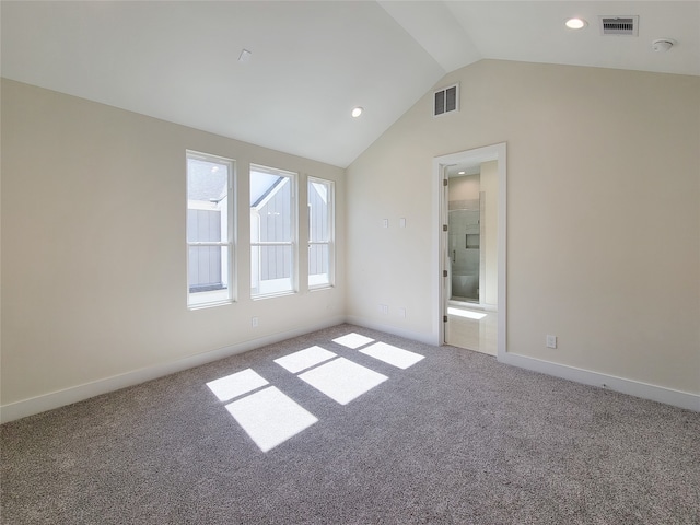 unfurnished room featuring carpet and vaulted ceiling