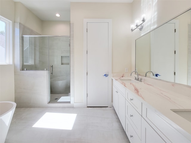 bathroom with vanity and separate shower and tub