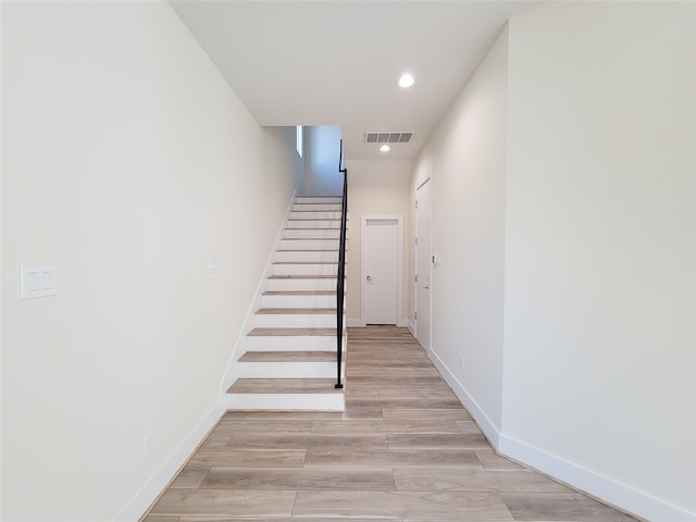 stairway with hardwood / wood-style floors