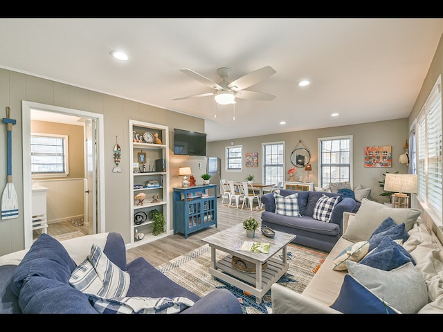 living room featuring ceiling fan and light wood-type flooring