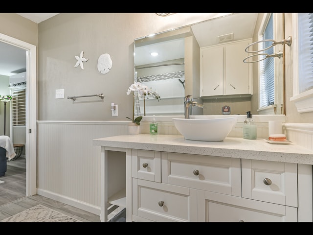 bathroom featuring an AC wall unit and vanity