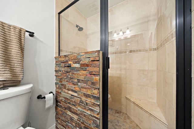 bathroom featuring toilet and walk in shower