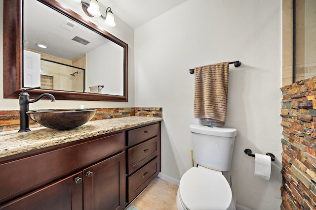 bathroom featuring vanity, toilet, a shower, and tile patterned flooring