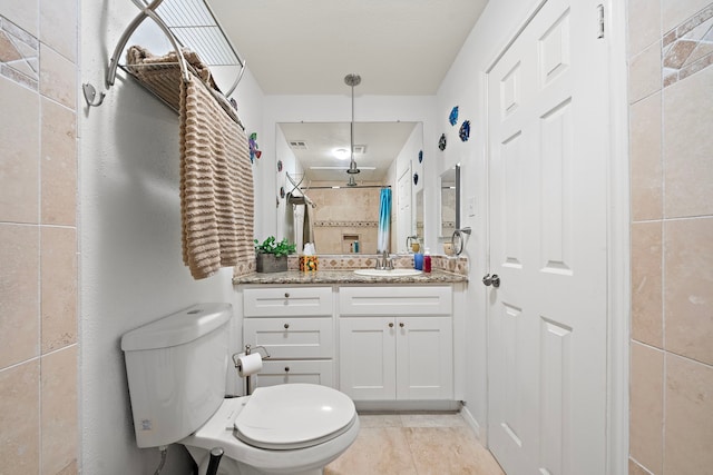 bathroom featuring toilet, vanity, and tile patterned floors