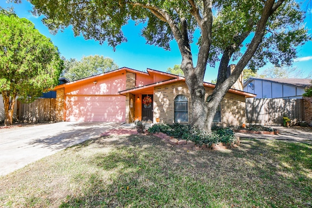 view of front of property featuring a garage and a front yard