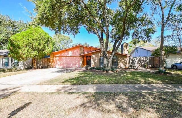 view of front of home featuring a front yard and a garage