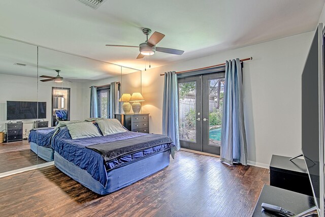 bedroom featuring wood finished floors, visible vents, baseboards, access to outside, and french doors