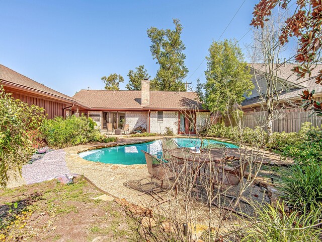 view of pool featuring a fenced in pool, outdoor dining space, a patio area, and fence