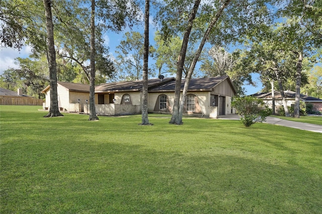 single story home with a front lawn and a garage