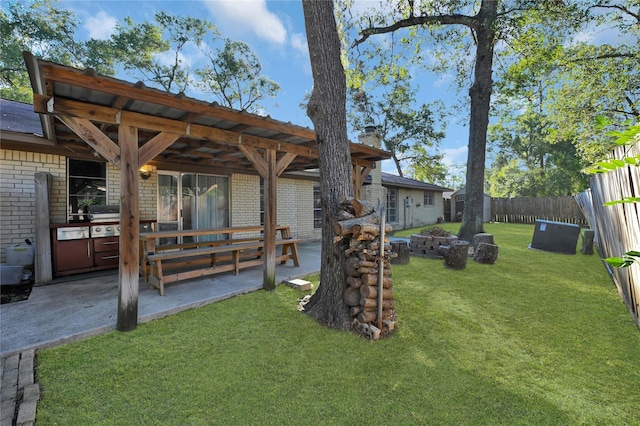 view of yard with area for grilling and a patio area