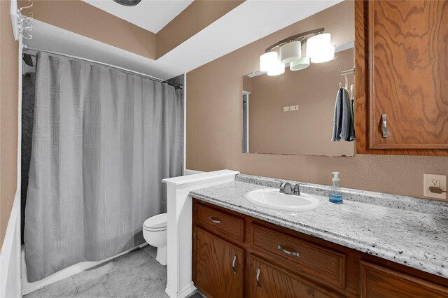 bathroom with tile patterned flooring, vanity, and toilet