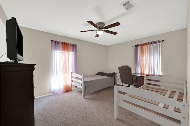 bedroom with ceiling fan and light carpet