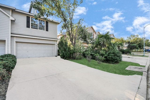 6059 Shelbourne Park Ln, Houston, TX 77084 - view of side of property with an attached garage and concrete driveway