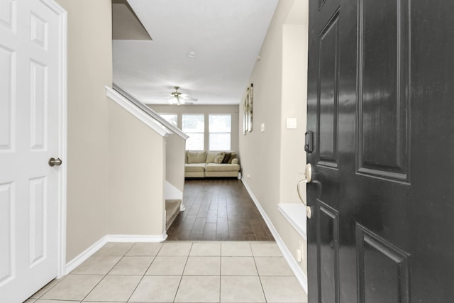 foyer featuring ceiling fan and light tile patterned floors