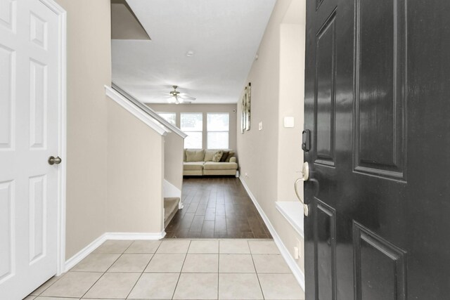 6059 Shelbourne Park Ln, Houston, TX 77084 - entryway featuring a ceiling fan, baseboards, light tile patterned flooring, and stairway