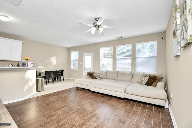 living room with ceiling fan, a wealth of natural light, and hardwood / wood-style floors