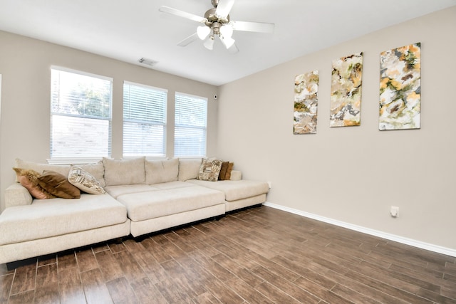 living room with dark wood-type flooring and ceiling fan