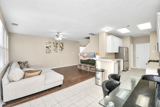 living room featuring light hardwood / wood-style floors and ceiling fan