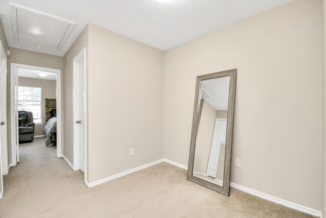 6059 Shelbourne Park Ln, Houston, TX 77084 - corridor featuring attic access, light carpet, and baseboards