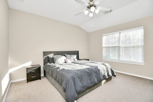 bedroom featuring lofted ceiling, light colored carpet, and ceiling fan