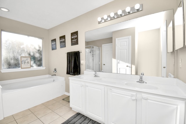 bathroom with vanity, tile patterned floors, and plus walk in shower