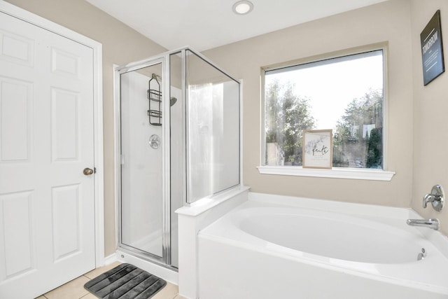 6059 Shelbourne Park Ln, Houston, TX 77084 - bathroom featuring a shower stall, a garden tub, and tile patterned flooring