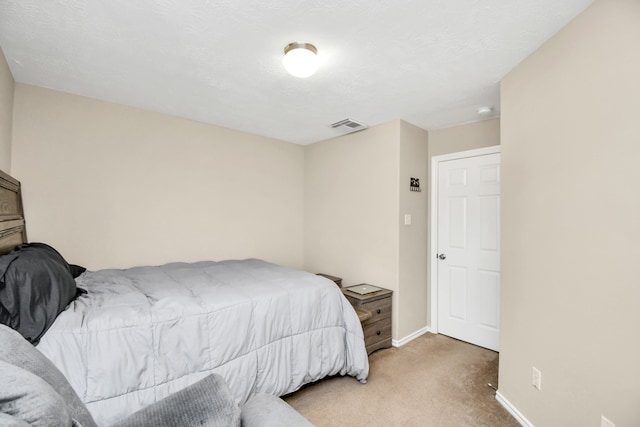 carpeted bedroom featuring a textured ceiling