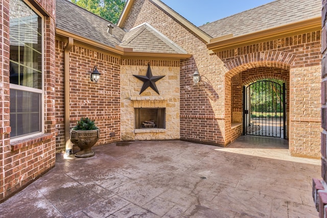 view of patio featuring an outdoor stone fireplace