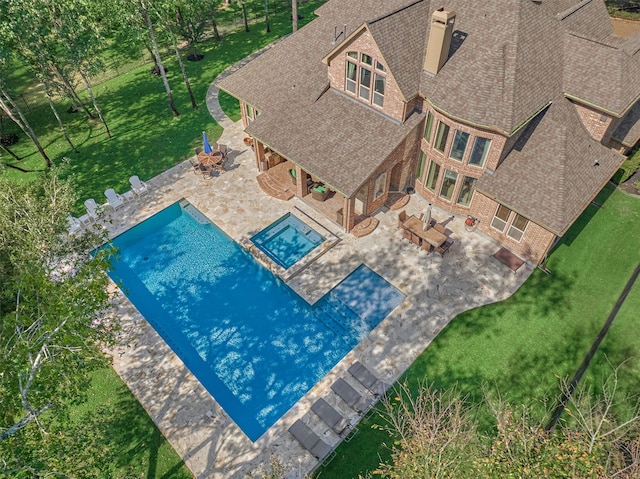 view of pool with a patio area, a yard, and an outdoor living space