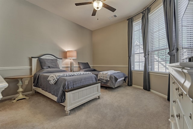 bedroom featuring light colored carpet and ceiling fan