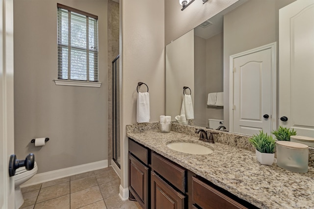 bathroom featuring vanity, tile patterned floors, toilet, and walk in shower