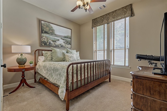 bedroom with ceiling fan and light colored carpet