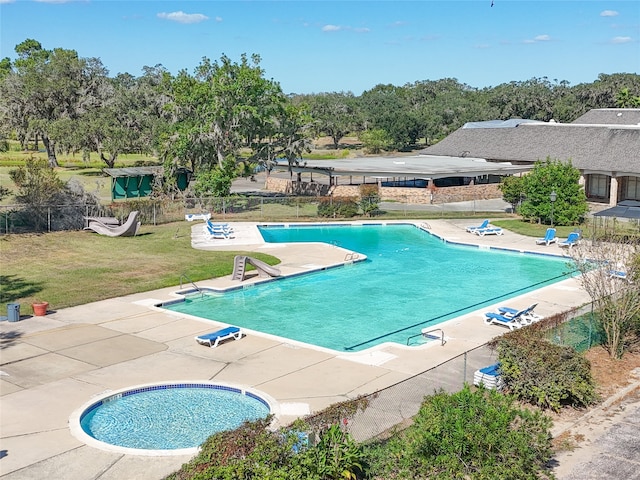 view of pool with a patio area and a yard