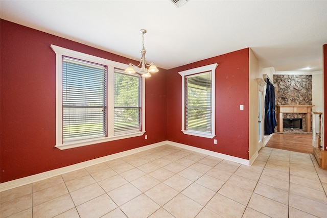 unfurnished dining area with a notable chandelier and light tile patterned floors