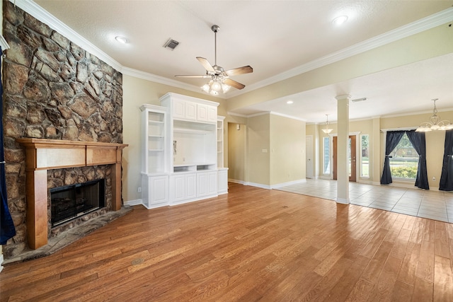 unfurnished living room with a stone fireplace, light hardwood / wood-style flooring, and ornamental molding