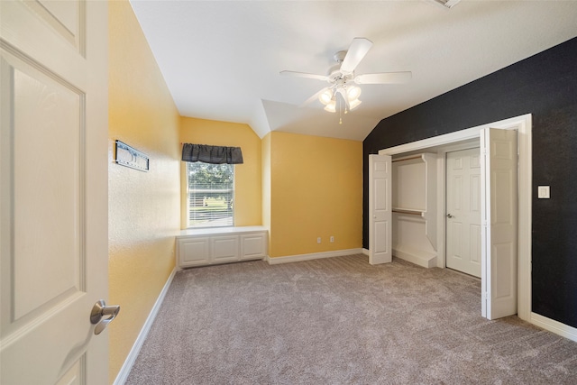 unfurnished bedroom with vaulted ceiling, light colored carpet, and ceiling fan