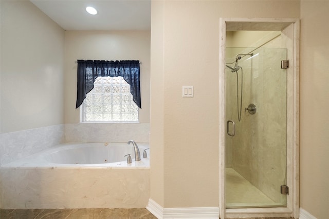 bathroom featuring shower with separate bathtub and tile patterned flooring